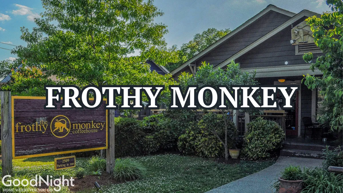 The exterior of Frothy Monkey is shown with distinctive signage, lush landscaping, and a welcoming entrance pathway. The inviting setup encourages visitors to linger, socialize, and enjoy artisanal coffee, tying in with the section’s mention of top local cafés.