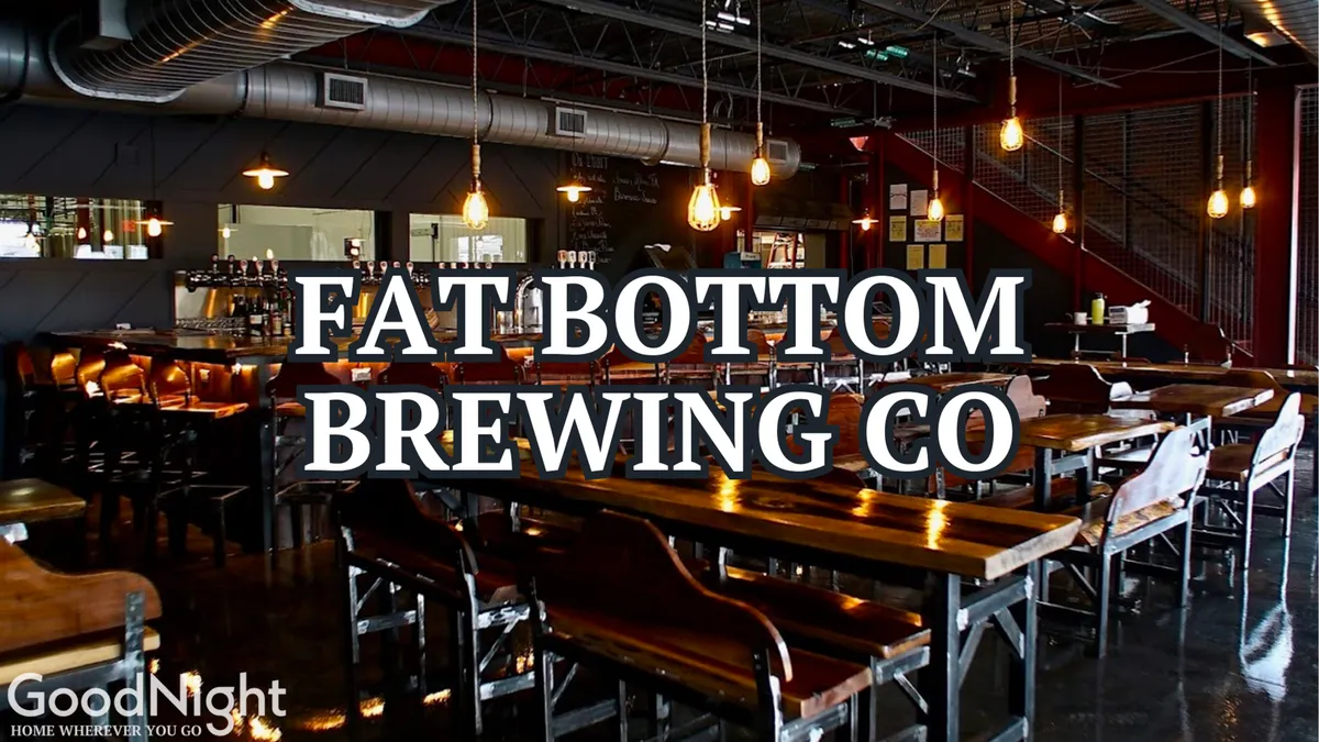 Inside a bustling local hotspot, this image features large communal tables, exposed lighting, a lively bar area, and decorative wall elements. The vibe is casual and energetic, perfect for beer tastings, casual dining, and social gatherings—reflective of Nashville’s vibrant eat-and-drink culture.